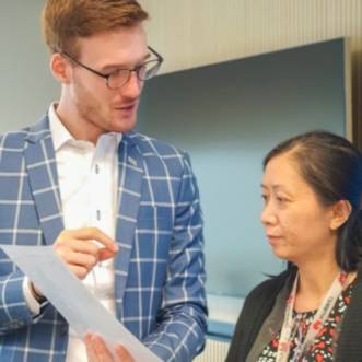 Caucasian doctor teaching female employee