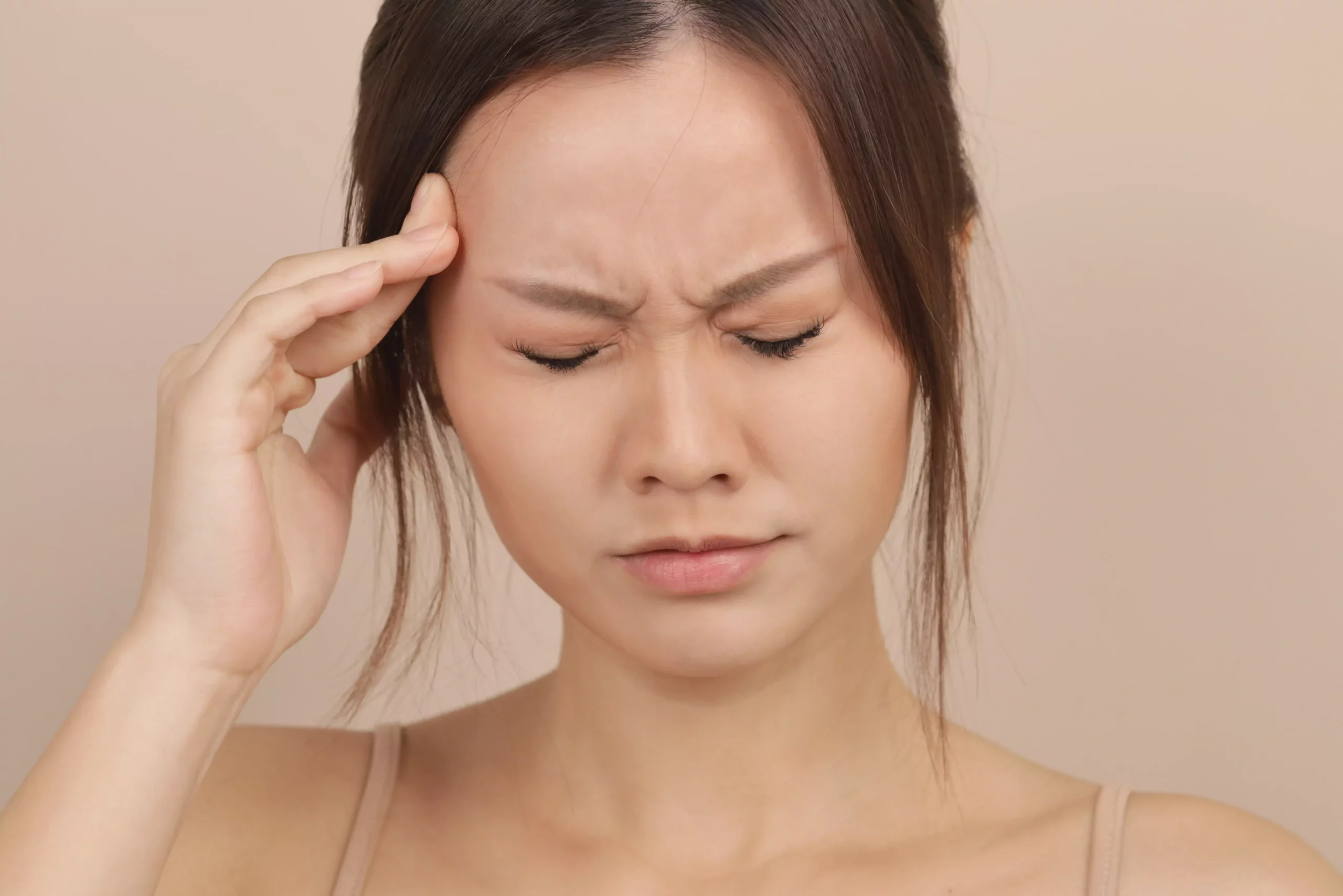 Woman holding her temple during a headache