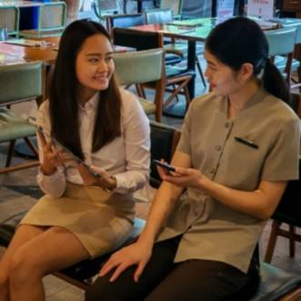 Two Singaporean Employees discussing at canteen