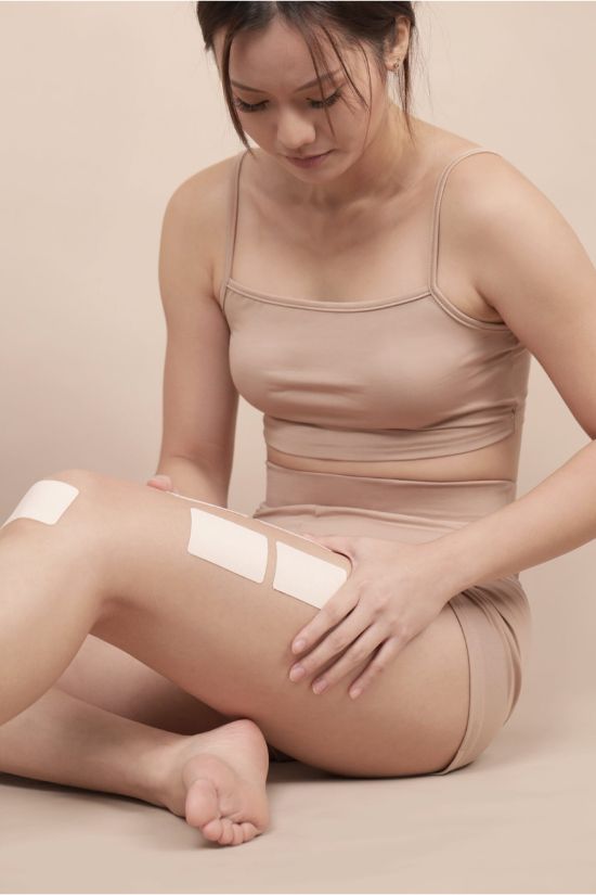 female with salonpas pain relieve patch on leg
