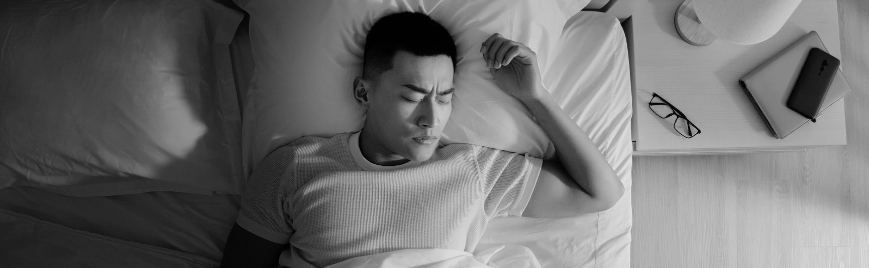 Man lying awake in bed at night