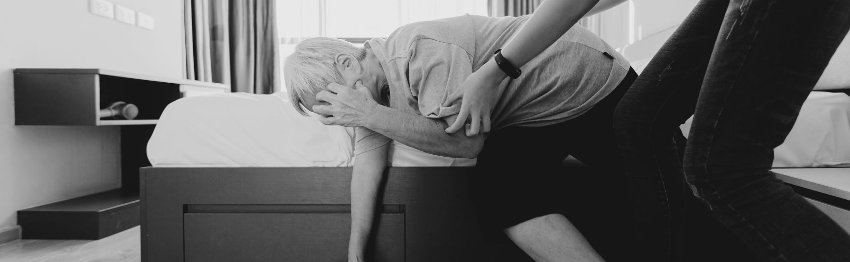 Older man holding his head and steadying himself while dizzy