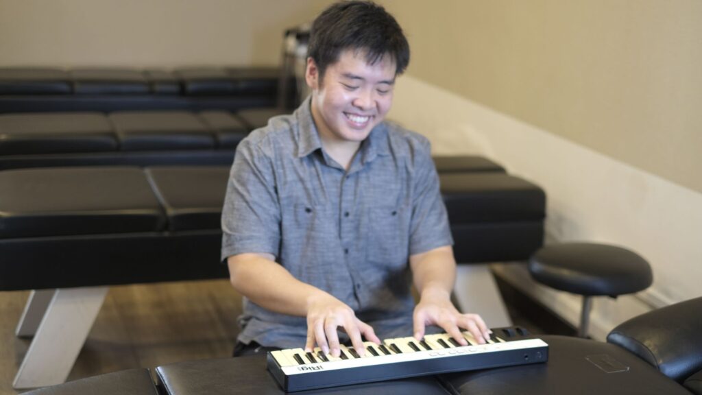 Chiropractor Lucas Ong playing piano at Bedok clinic