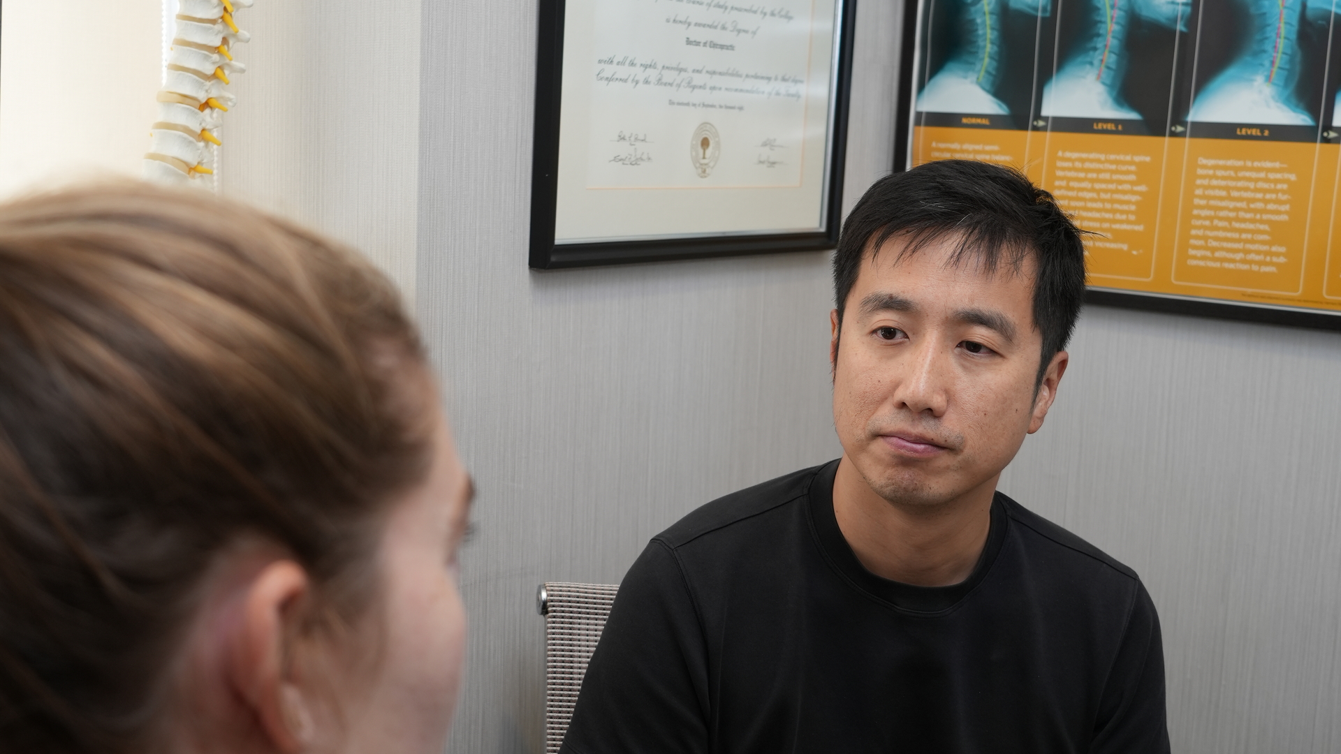 Chiropractor explaining AI spinal analysis results