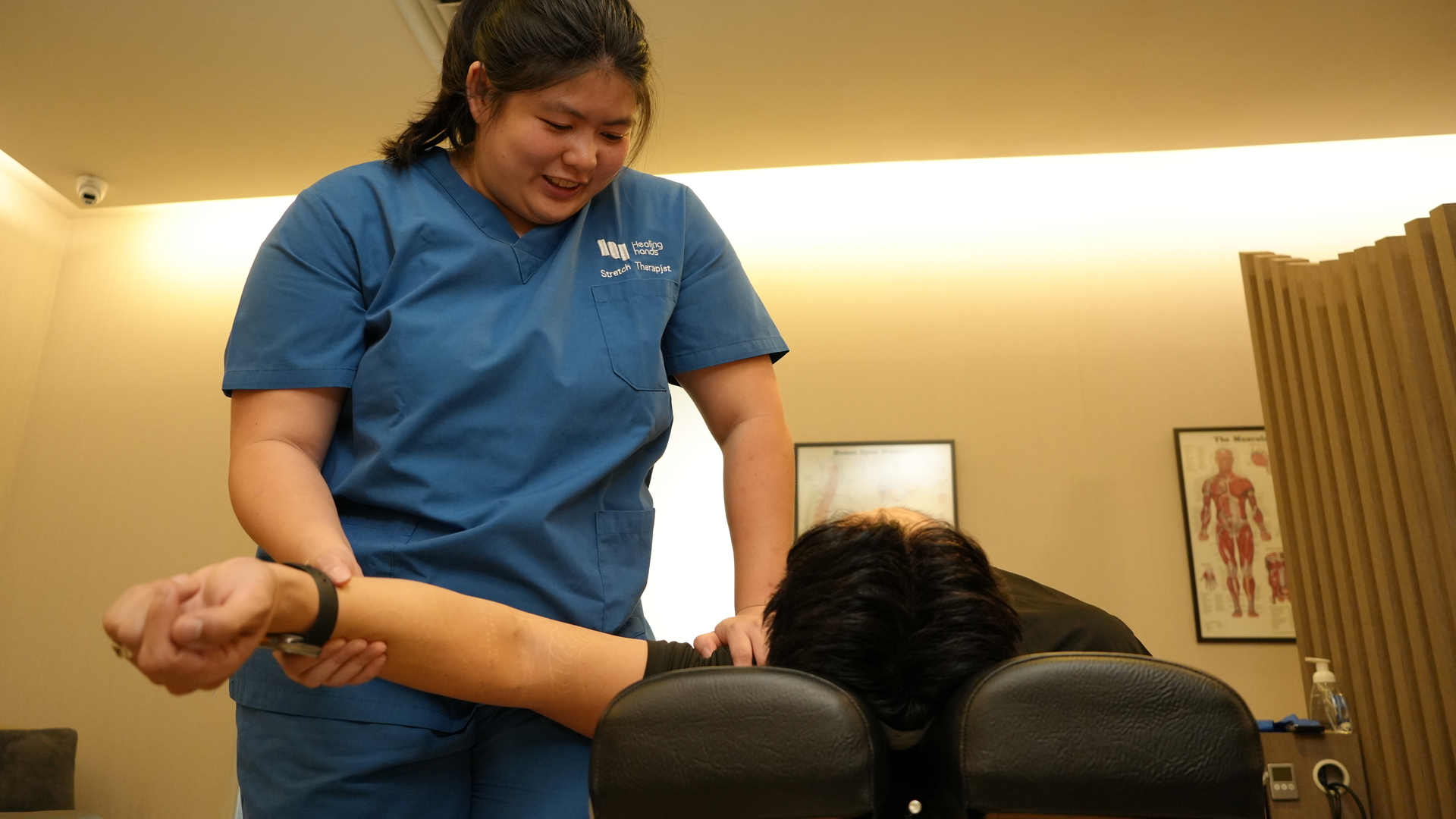 Therapist-assisted stretch of arm and shoulder