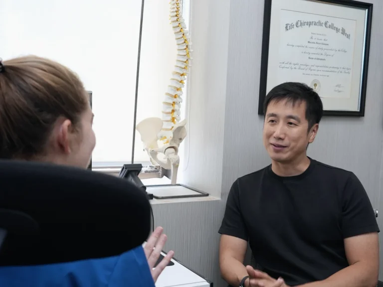 Chiropractor in a one-to-one consultation with a patient