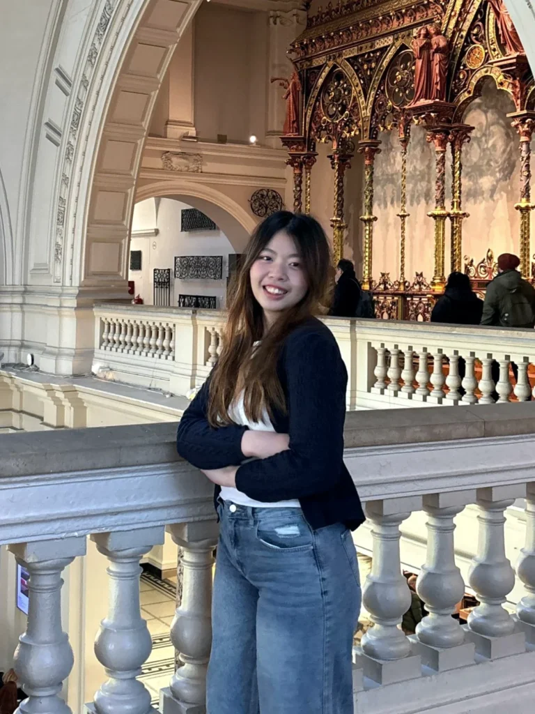 Hui Yi, chiropractor at Healing Hands Wellness, smiling at a museum gallery